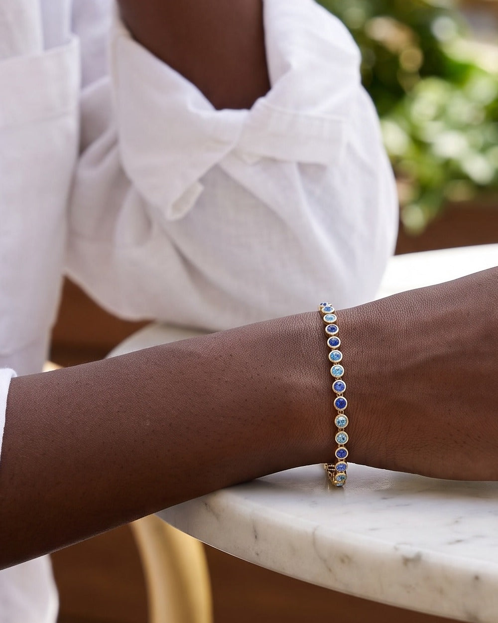 Bracelet rivière bleu roi doré porté au poignet